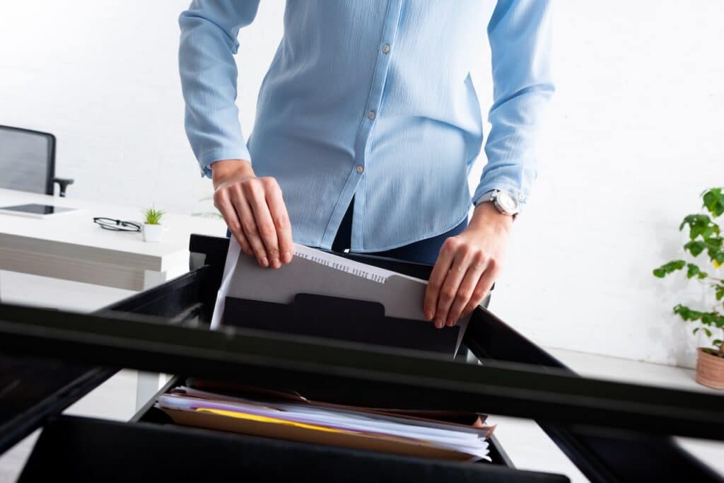 Man pulling files out of a filing cabinet