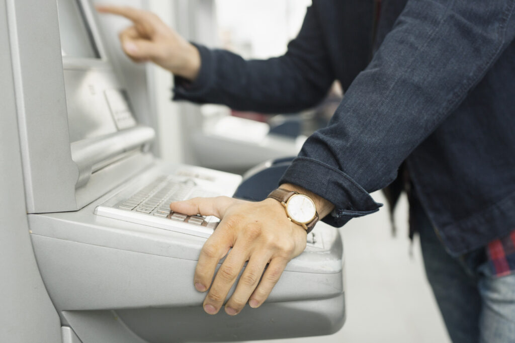 Man inputs information into an ATM