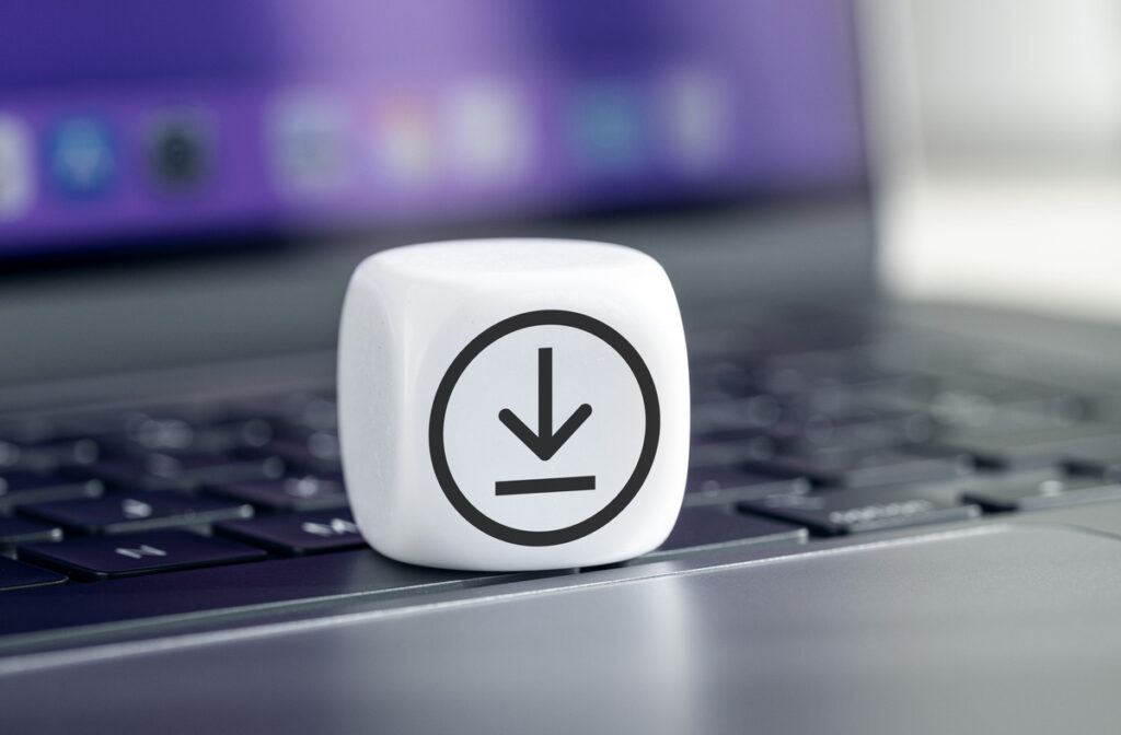 Download icon on a dice cube that's sitting on a keyboard