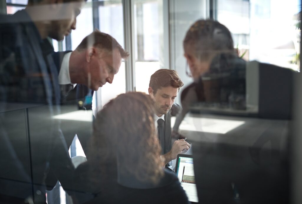 employees in a meeting discussing bank cybersecurity